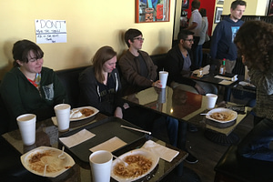 The Year of Service group takes a quick break from their service and enjoy a meal filled with discussion.