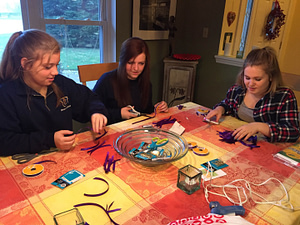 Members of the March of Dimes Year of Service Group assemble purple ribbons for World Prematurity Day on Nov. 17.