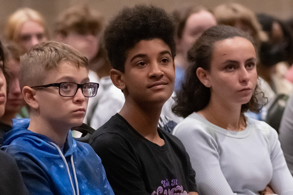 Student listens during the all-school morning meeting.